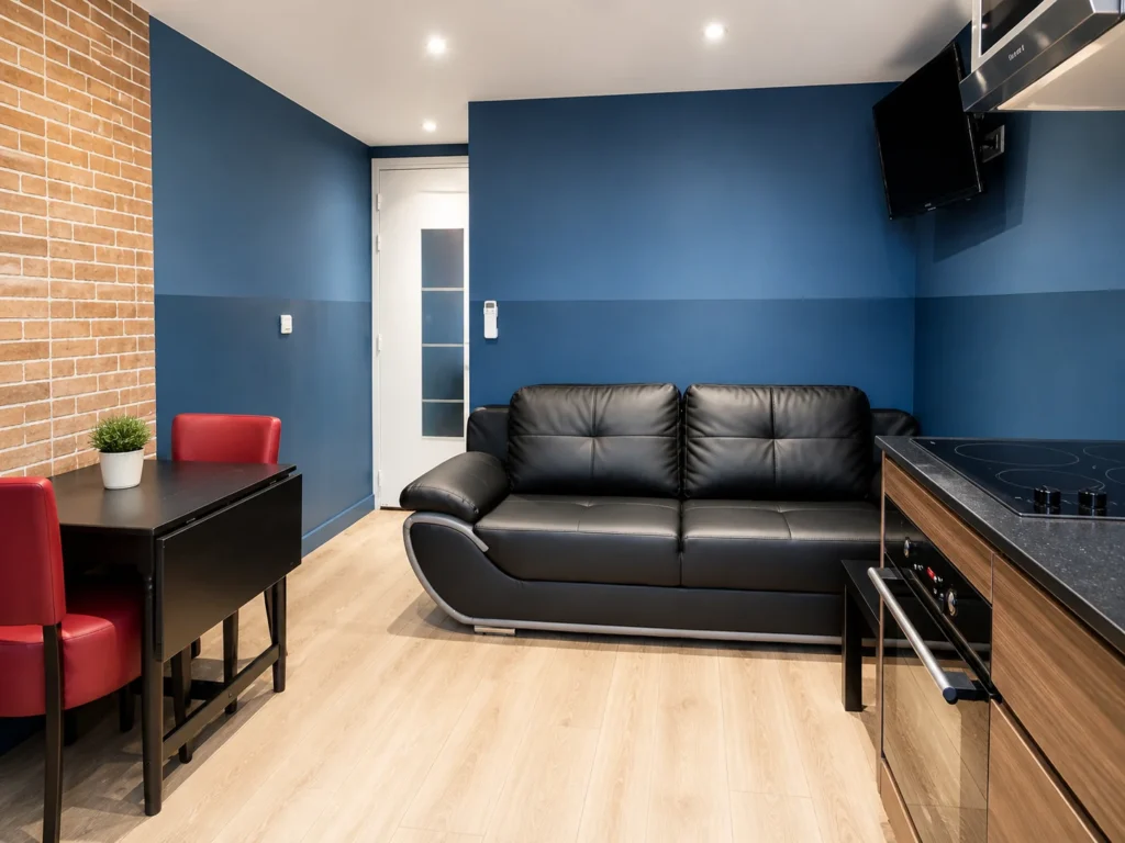 Salon avec canapé en cuir et coin repas – Studio Cosy, Carré d'Or Nice